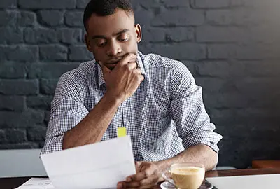 Man with detailed document containing the requirements and legal framework for the process of his denaturalization