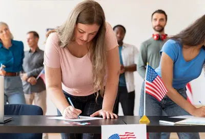 Woman fills out the necessary forms for the naturalization interview following the Citizenship Process in 2025