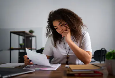 Woman reviewing notifications and documents from a Denaturalization Section