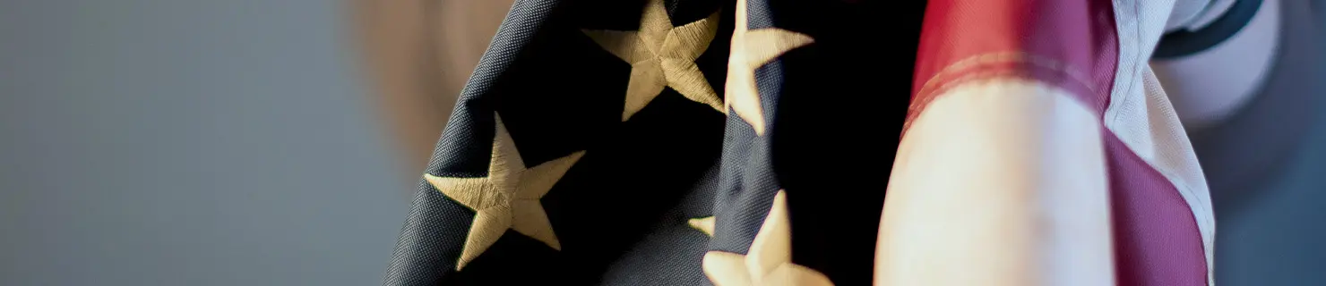 US flag being held by a person who has just received humanitarian asylum in Dallas